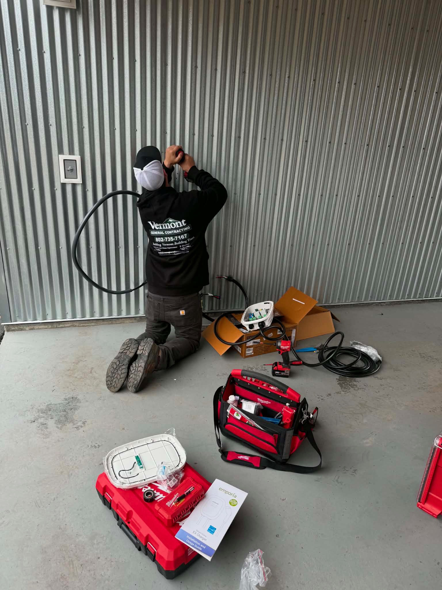 VTGC technician running conduit for EV charger installation