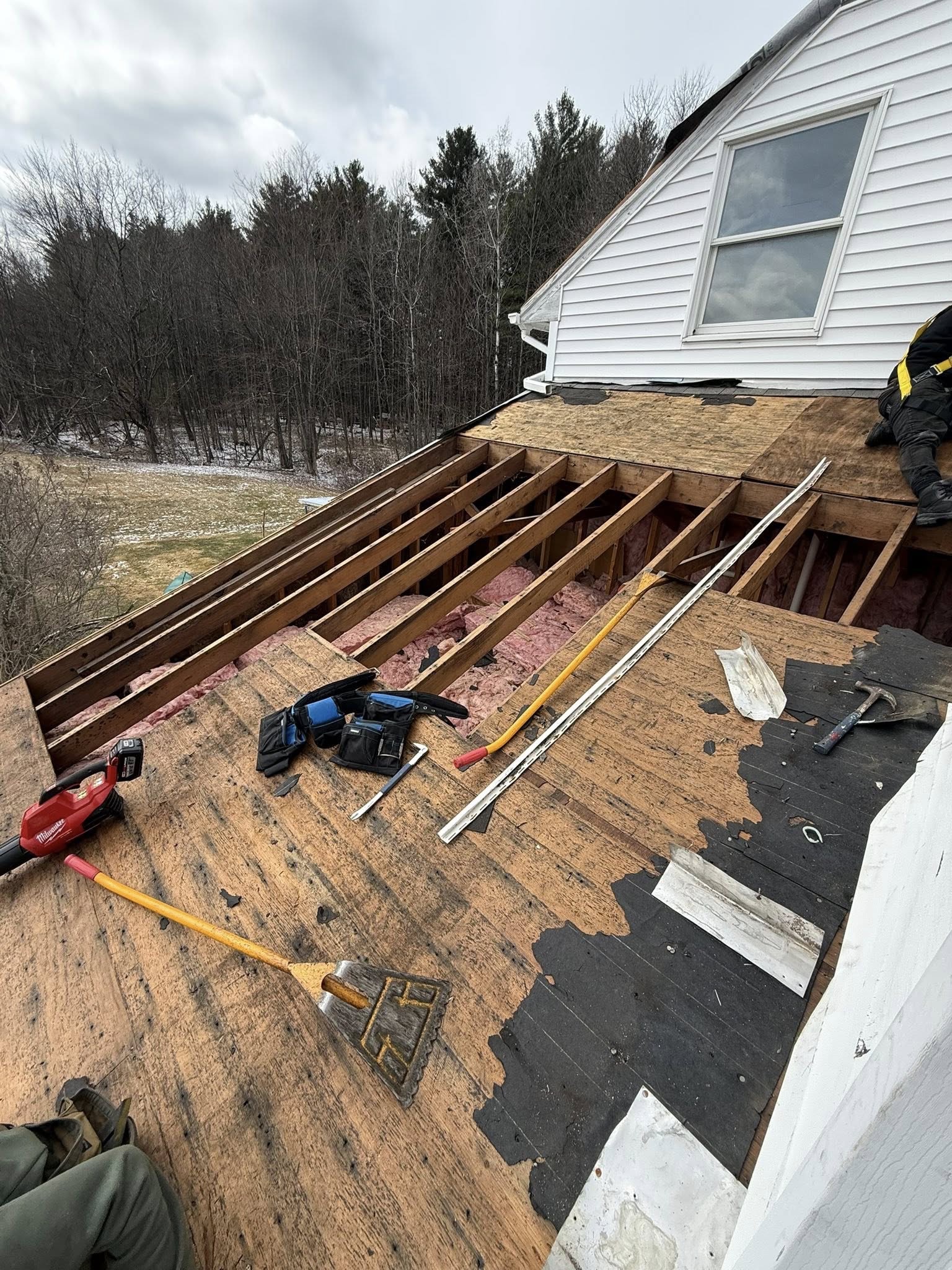 Underlayment laid with shingle bundles staged
